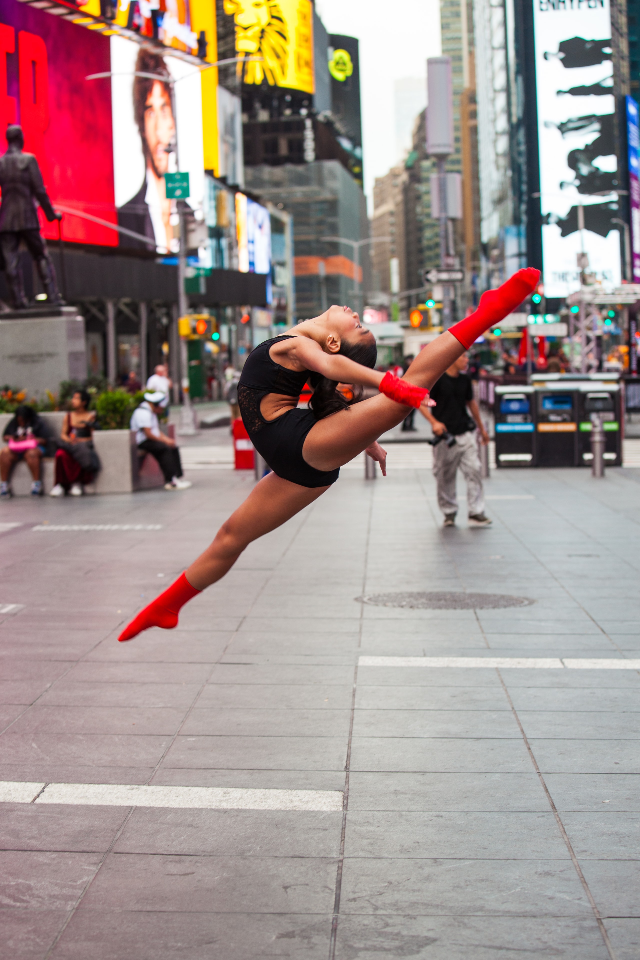 Dancer performing a split leap in Times Square NYC