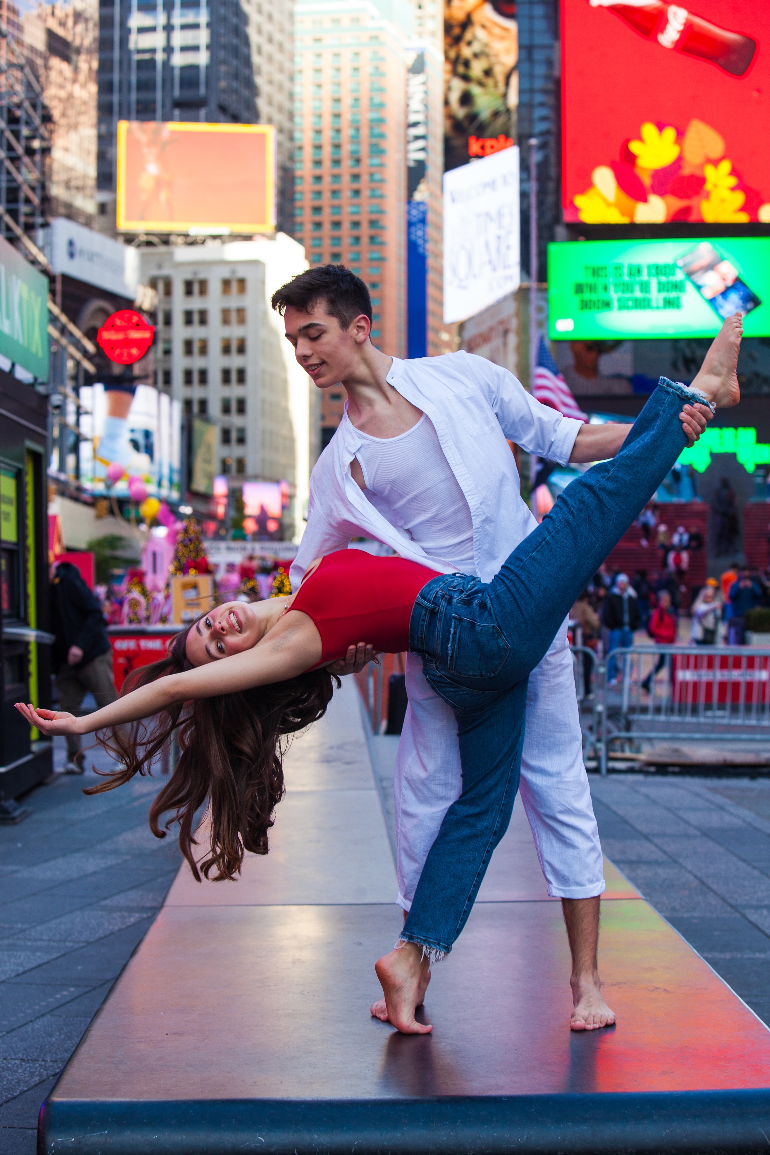 Two dancers performing a lift in Times Square NYC