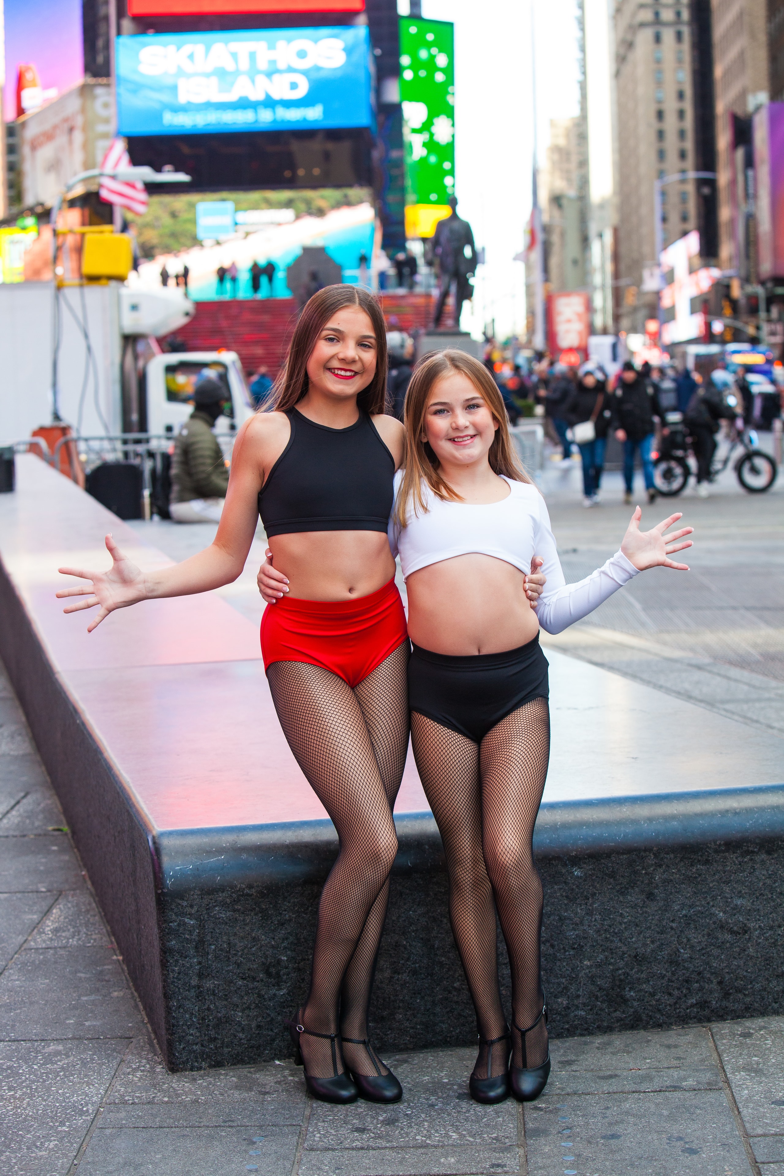 Two dancers posing together in Times Square NYC